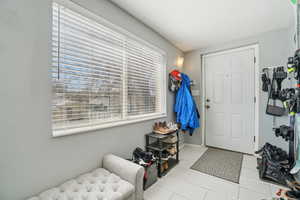 Foyer with light tile patterned floors