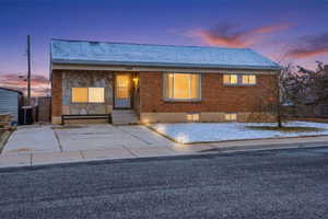 View of front of home featuring brick siding, stone siding, and entry steps