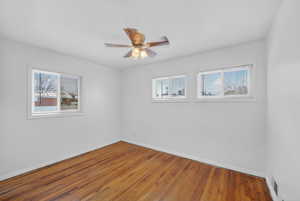 Unfurnished room featuring a ceiling fan and hardwood / wood-style floors