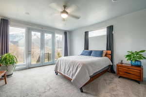 Carpeted bedroom featuring access to exterior, ceiling fan, and a textured ceiling