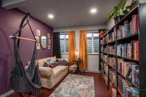 Living area with dark wood-style floors and recessed lighting