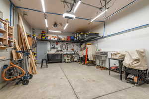 Garage featuring a workshop area and a garage door opener