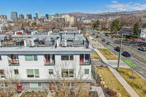 Bird's eye view of a mountain backdrop and apartment complex / building