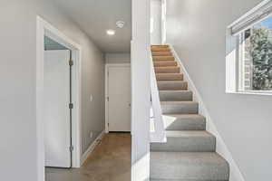 Stairs featuring recessed lighting and baseboards