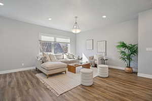 Living area featuring wood finished floors and recessed lighting