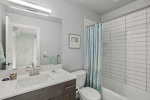 Full bathroom with vanity and shower / bath combo with shower curtain