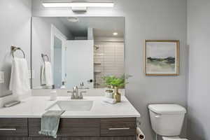 Full bathroom featuring tiled shower and vanity