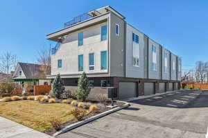 View of home's exterior featuring brick siding and stucco siding