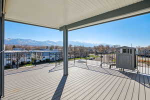 Wooden deck featuring a residential view and a mountain view