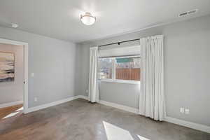 Unfurnished room with baseboards and concrete floors