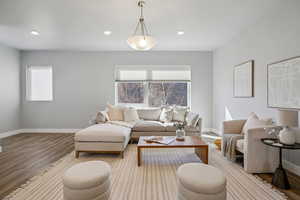 Living room featuring wood finished floors, healthy amount of natural light, and recessed lighting