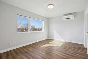 Empty room featuring dark wood-type flooring
