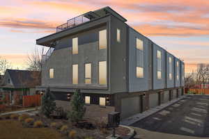 Property exterior at dusk featuring brick siding