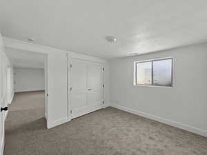 Unfurnished bedroom featuring carpet and a closet