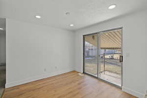 Unfurnished room featuring light wood-type flooring and recessed lighting