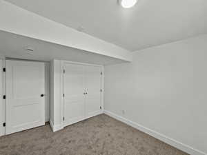 Unfurnished bedroom with carpet floors and a closet