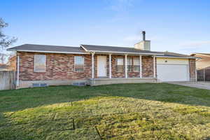Single story home with brick siding, a porch, an attached garage, and roof with shingles