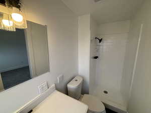 Bathroom featuring a shower stall and vanity