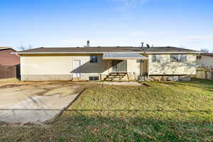 Rear view of property featuring entry steps and a patio