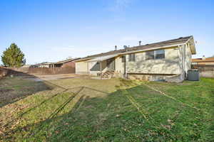 Rear view of property with entry steps, a fenced backyard, and a patio