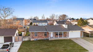 Traditional-style house with a residential view, brick siding, a gate, and concrete driveway