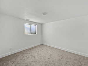 Unfurnished room featuring baseboards and carpet flooring