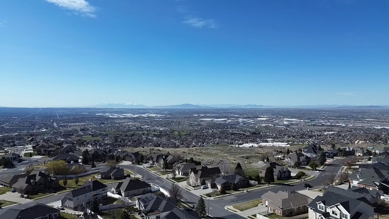Aerial perspective of suburban area with a mountain backdrop