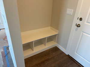 Mudroom with dark wood-style floors and baseboards