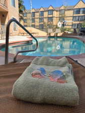 Community pool featuring a patio