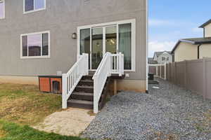 Rear entrance to property with stucco siding