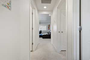 Corridor with recessed lighting and baseboards