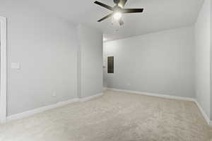 Spare room featuring ceiling fan, light colored carpet