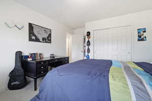 Bedroom with a closet and carpet flooring