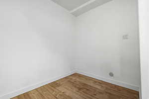 Spare room with baseboards and light wood finished floors