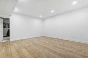 Spare room with light wood-type flooring and recessed lighting