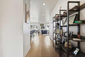 Corridor featuring recessed lighting and light wood flooring