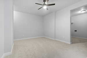 Spare room with light colored carpet and ceiling fan