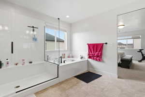 Ensuite master bathroom featuring a stall shower, a bath, and recessed lighting