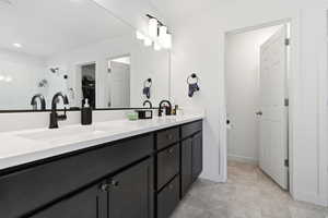 Master Bathroom with double vanity and a walk in closet