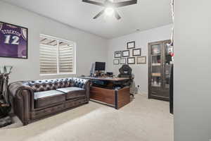 Bedroom/Office space featuring light colored carpet and a ceiling fan