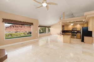 Kitchen with a ceiling fan, open shelves, stainless steel appliances, dark countertops, and a chandelier