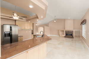 Kitchen with ceiling fan, stainless steel fridge, recessed lighting, a fireplace, and open floor plan