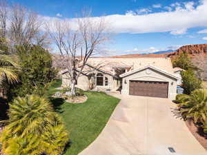 Mediterranean / spanish-style home featuring a garage, stucco siding, driveway, a mountain view, and a tiled roof