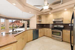 Kitchen featuring electric stove, open shelves, decorative backsplash, freestanding refrigerator, and dishwasher