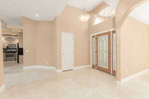 Foyer with arched walkways and a high ceiling