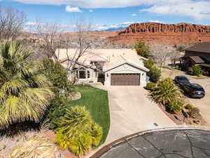Mediterranean / spanish-style house with driveway, a garage, stucco siding, a mountain view, and a tile roof