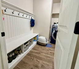 Mudroom featuring light wood finished floors and washer / dryer