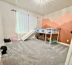 Carpeted bedroom featuring baseboards