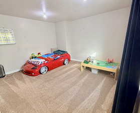Bedroom featuring a textured ceiling and carpet