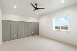 Unfurnished bedroom featuring light colored carpet, a ceiling fan, recessed lighting, a closet, and lofted ceiling